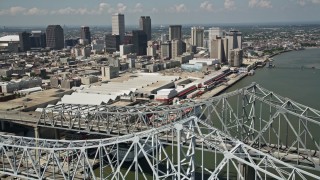 AX59_011E - 5K aerial stock footage flying over the Crescent City Connection, with view of convention center and Downtown New Orleans, Louisiana