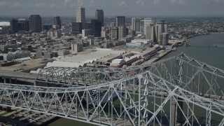 AX59_012 - 5K aerial stock footage flying over the Crescent City Connection, with view of convention center and Downtown New Orleans, Louisiana