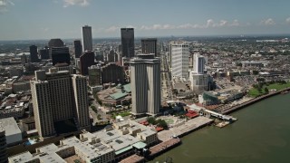 AX59_014 - 5K aerial stock footage of Hilton New Orleans and World Trade Center building in Downtown New Orleans, Louisiana