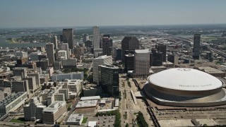 AX59_021E - 5K aerial stock footage approach Downtown New Orleans skyscrapers and Mercedes-Benz Superdome, Louisiana
