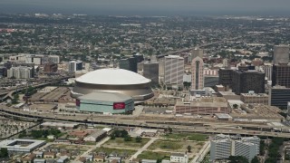 AX59_028 - Aerial stock footage of 5K aerial  video of Mercedes-Benz Superdome and New Orleans Arena, New Orleans, Louisiana