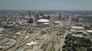 AX59_039 - 5K aerial stock footage approach the freeway interchange by the Superdome, and Downtown New Orleans skyscrapers, Louisiana
