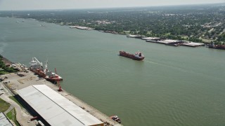 AX59_055 - 5K aerial stock footage of an oil tanker sailing on Mississippi River, New Orleans, Louisiana