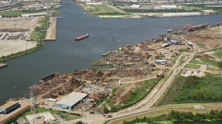 AX59_059 - 5K aerial stock footage tilt to a bird's eye view of dump on bank of Industrial Canal, New Orleans, Louisiana