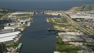 AX59_063 - 5K aerial stock footage follow Industrial Canal toward the Seabrook Floodgate, New Orleans, Louisiana