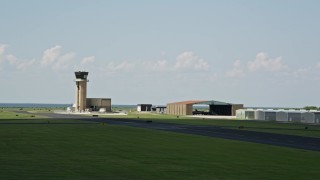 AX59_067 - 5K aerial stock footage of control tower and hangers at New Orleans Lakefront Airport, Louisiana