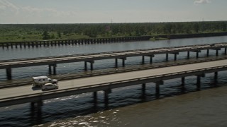AX60_006 - 5K aerial stock footage of Interstate 10 with light traffic on the shore of Lake Pontchartrain in Norco, Louisiana