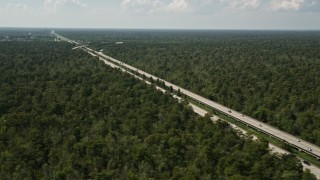 AX60_010 - 5K aerial stock footage of Interstate 10 through swampland in La Place, Louisiana