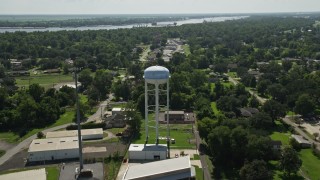 AX60_013 - 5K aerial stock footage fly over trailer park and approach a water tower, La Place, Louisiana