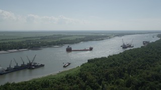 AX60_014 - 5K aerial stock footage approach cargo ships anchored on Mississippi River near LaPlace, Louisiana