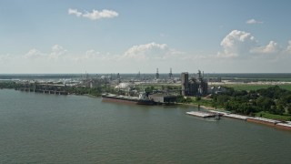 AX60_018E - 5K aerial stock footage a grain elevator and cargo ship near oil refinery in Reserve, Louisiana