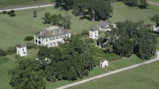 AX60_025 - 5K aerial stock footage flying by the Evergreen Plantation house in Edgard, Louisiana
