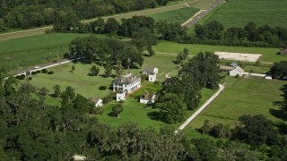 AX60_025E - 5K aerial stock footage orbiting the Evergreen Plantation house in Edgard, Louisiana