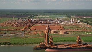 AX60_031 - 5K aerial stock footage of Gramercy Alumina plant and docked cargo ship in Gramercy, Louisiana