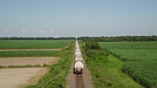 AX60_062 - 5K aerial stock footage approach the end of a train and fly over several rail cars in Vacherie, Louisiana