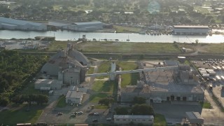 AX61_001 - 5K aerial stock footage of a factory near Industrial Canal at sunset, New Orleans, Louisiana