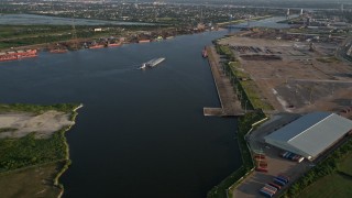 AX61_004 - 5K aerial stock footage approach a barge sailing on Industrial Canal at sunset, New Orleans, Louisiana