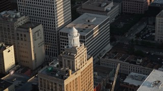 AX61_012 - 5K aerial stock footage of the top of Hibernia Bank Building at sunset, Downtown New Orleans, Louisiana