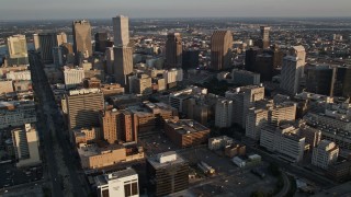 AX61_017 - 5K aerial stock footage of skyscrapers and city buildings at sunset in Downtown New Orleans, Louisiana