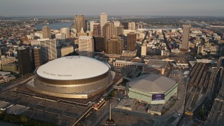 AX61_018 - 5K aerial stock footage orbit Superdome, New Orleans Arena in Downtown New Orleans at sunset, Louisiana