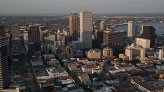 AX61_019 - 5K aerial stock footage of Plaza Tower and Downtown New Orleans skyscrapers at sunset, Louisiana