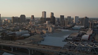 AX61_022 - 5K aerial stock footage flyby Crescent City Connection Bridge at sunset to focus on Downtown New Orleans, Louisiana