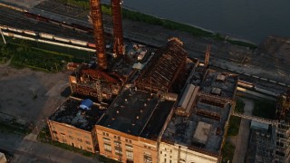 AX61_023 - 5K aerial stock footage old power plant on bank of Mississippi River at sunset, New Orleans, Louisiana