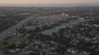 AX61_030 - 5K aerial stock footage of Greenwood Cemetery and First Baptist New Orleans church at sunset, Lakeview, Louisiana