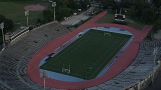 AX61_033 - 5K aerial stock footage approach Tad Gormley Stadium in City Park at sunset, New Orleans, Louisiana