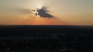 AX61_034 - 5K aerial stock footage of the sun behind a cloud over Lakeview District, New Orleans, Louisiana