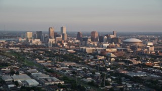 AX61_035 - 5K aerial stock footage approach skyscrapers in Downtown New Orleans at sunset, Louisiana