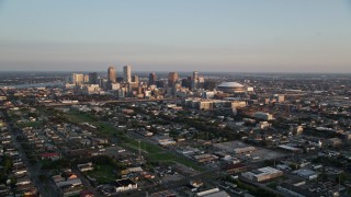 AX61_036 - 5K aerial stock footage approach high-rises and skyscrapers in Downtown New Orleans at sunset, Louisiana