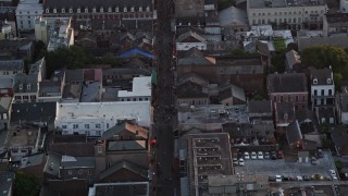 AX61_043E - 5K aerial stock footage follow famous Bourbon Street through French Quarter, New Orleans at sunset, Louisiana