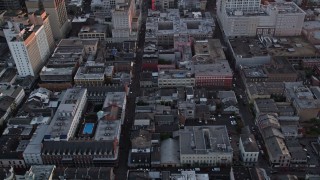 AX61_059 - 5K aerial stock footage of French Quarter's famous Bourbon Street and cross streets at sunset, New Orleans, Louisiana