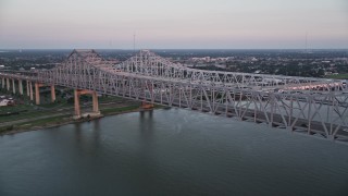 AX61_065 - 5K aerial stock footage of light traffic on the Crescent City Connection Bridge at sunset, New Orleans, Louisiana