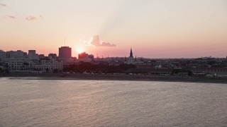 AX61_067 - 5K aerial stock footage of setting sun behind St. Louis Cathedral in the French Quarter, New Orleans, Louisiana