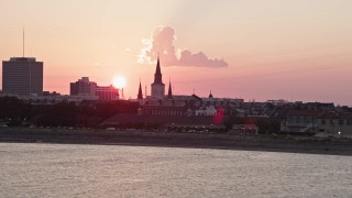 AX61_068 - 5K aerial stock footage of St. Louis Cathedral in the French Quarter of New Orleans, seen from the river at sunset, Louisiana