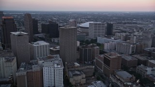 AX61_072 - 5K aerial stock footage of passing high-rises and skyscrapers in Downtown New Orleans at sunset, Louisiana