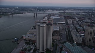 AX61_073 - 5K aerial stock footage track the World Trade Center and Hilton Riverside Hotel in Downtown New Orleans at sunset, Louisiana