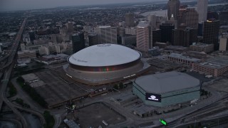 AX61_076 - 5K aerial stock footage orbit the Superdome and New Orleans Arena at sunset, Downtown New Orleans, Louisiana