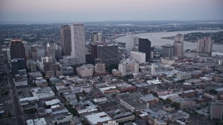 AX61_077 - 5K aerial stock footage flyby Plaza Tower and skyscrapers in Downtown New Orleans at sunset, Louisiana