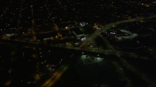 AX62_004 - 5K aerial stock footage of slow moving traffic on Mid-City New Orleans city streets at night, Louisiana