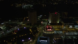 AX62_008E - 5K aerial stock footage follow Poydras Street to hotels in Downtown New Orleans at night, Louisiana