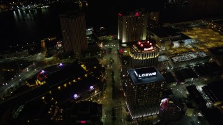 AX62_014 - 5K aerial stock footage follow Poydras Street past hotels in Downtown New Orleans at night, Louisiana