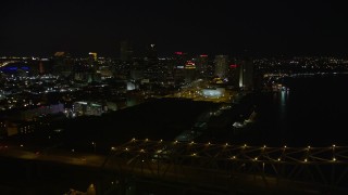 AX62_017 - 5K aerial stock footage of Crescent City Connection Bridge and Downtown New Orleans, Louisiana at night