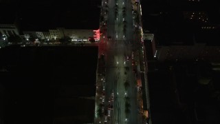 AX62_019 - 5K aerial stock footage of bird's eye view of Canal Street through Downtown New Orleans at night, Louisiana