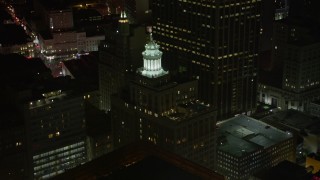 AX62_025 - 5K aerial stock footage of the top of the Hibernia Bank Building at night, Downtown New Orleans, Louisiana