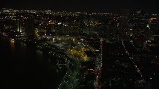 AX62_029E - 5K aerial stock footage tilt from Jax Brewery to reveal Downtown New Orleans at night, Louisiana