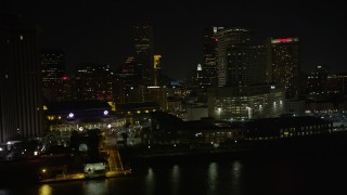 AX62_035 - 5K aerial stock footage fly low by Harrah's and hotels in Downtown New Orleans at night, Louisiana
