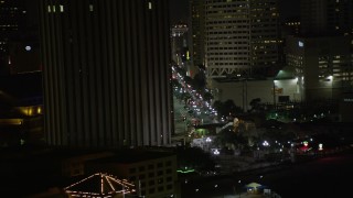 AX62_038 - 5K aerial stock footage track Harrah's New Orleans and reveal Canal Street at night, Downtown New Orleans, Louisiana